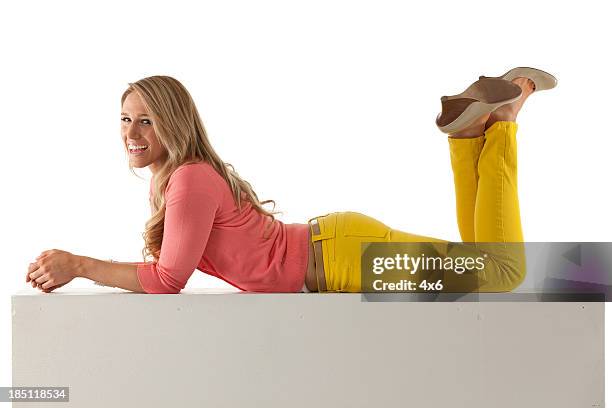 beautiful woman lying on a ledge - ligga på mage bildbanksfoton och bilder