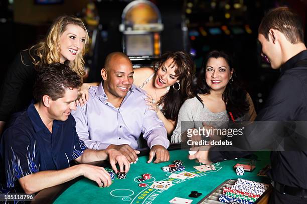 diverse group of people playing blackjack in a casino - casino dealer stockfoto's en -beelden