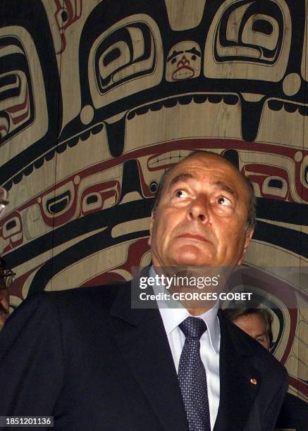 French President Jacques Chirac looks at a wooden wall painted and decorated by North American Indians during his visit the Museum of Civilizations...