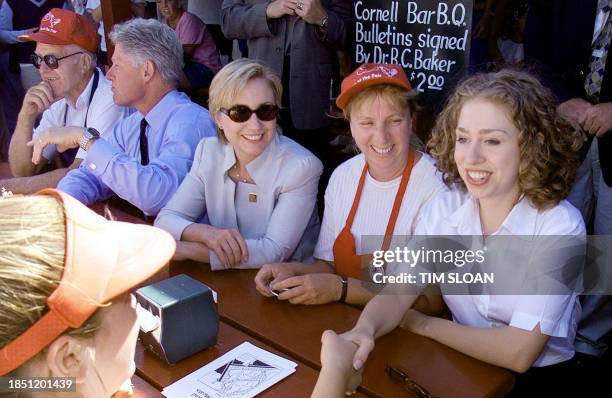 President Bill Clinton , First Lady Hillary Rodham Clinton and their daughter Chelsea talk with workers at the Baker's Chicken Coop booth at the New...