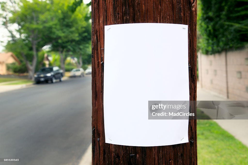 Blank piece of paper hanging on the telephone pole 