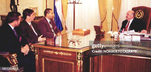 Paraguayan President Luis Gonzales Macchi speaks with Jose Luis Chilvert , presidential worker Jaime Bestar , and the head of the Paraguayan soccer...