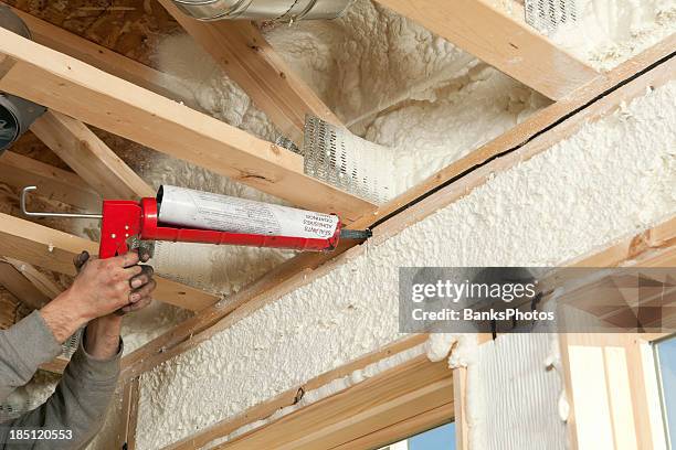 worker caulking window header - insulator stock pictures, royalty-free photos & images