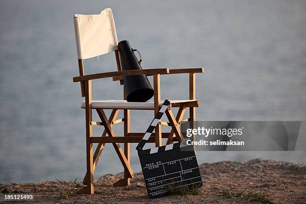 director's chair in outdoor with megaphone and film slate. - filmen stockfoto's en -beelden