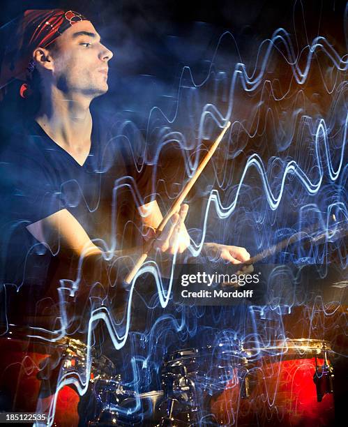 musician playing drums in dark with pulsating light trace - hitting drum stock pictures, royalty-free photos & images