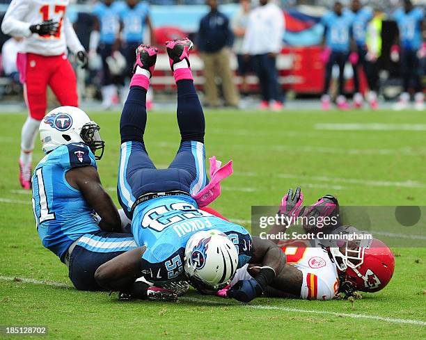 Junior Hemingway of the Kansas City Chiefs is tackled by Bernard Pollard and Moise Fokou of the Tennessee Titans at LP Field on October 6, 2013 in...