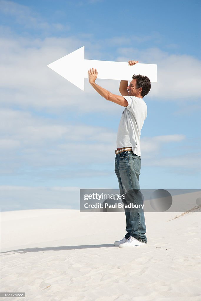 A man holding a directional arrow