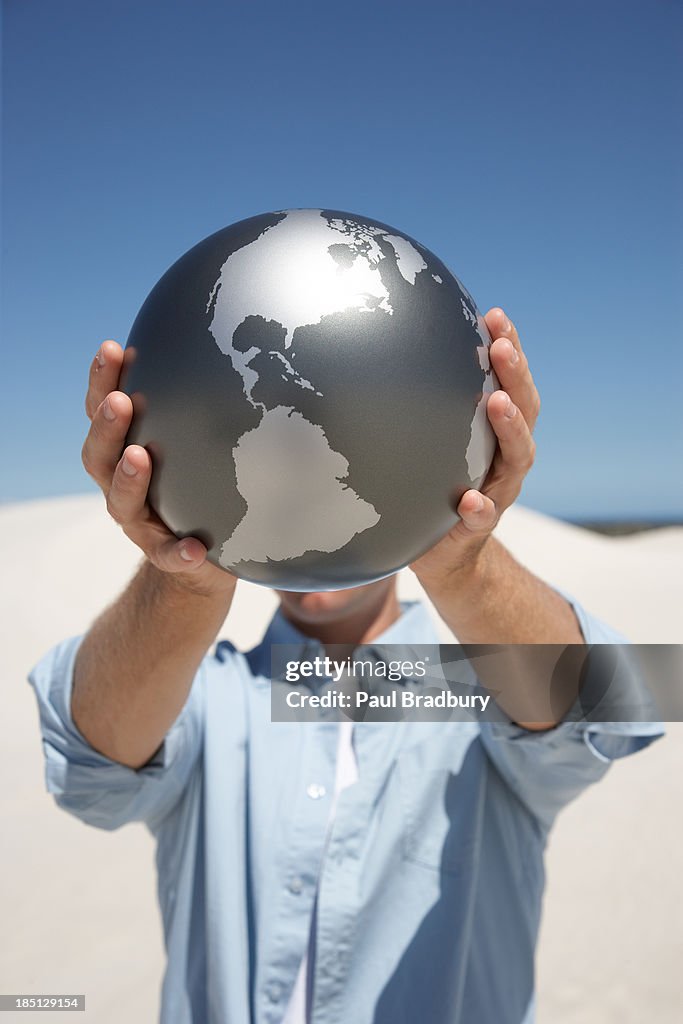 A man holding a globe