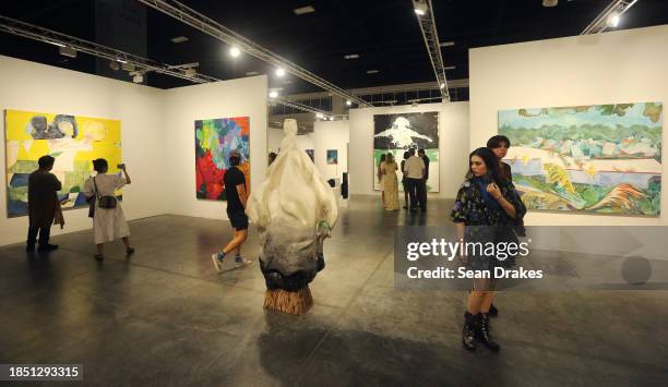 Guests view art works presented by White Cube Gallery at the Miami Beach Convention Center as part of Art Basel Miami Beach on December 9, 2023 in...