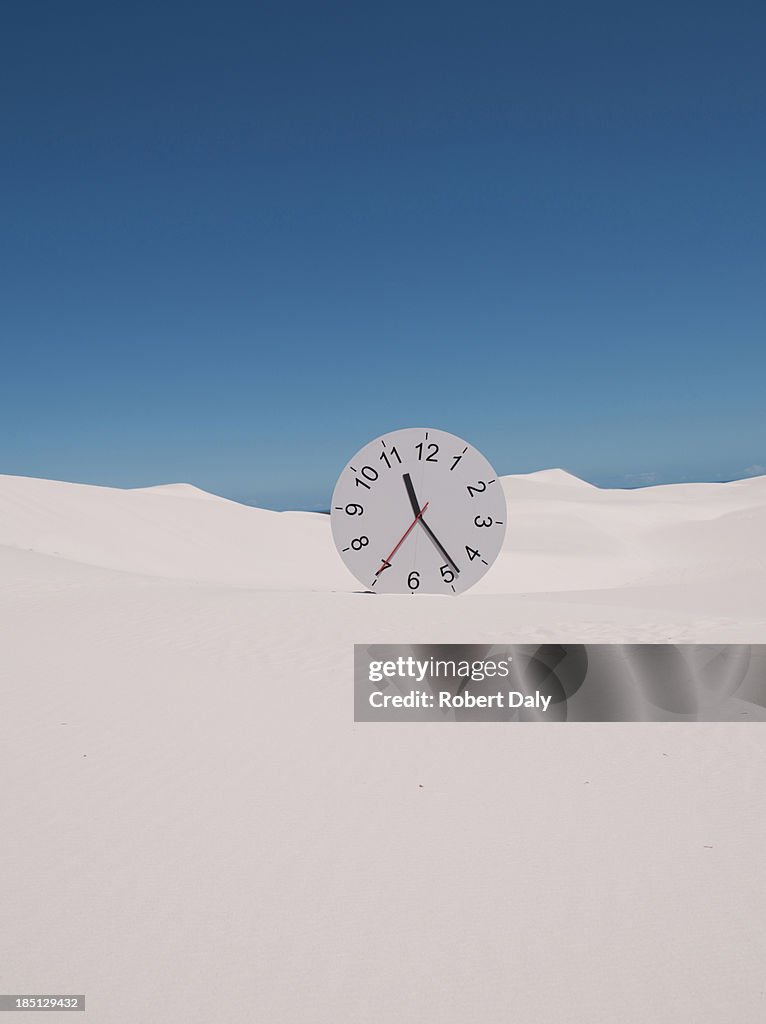 An oversized clock in the middle of a desert