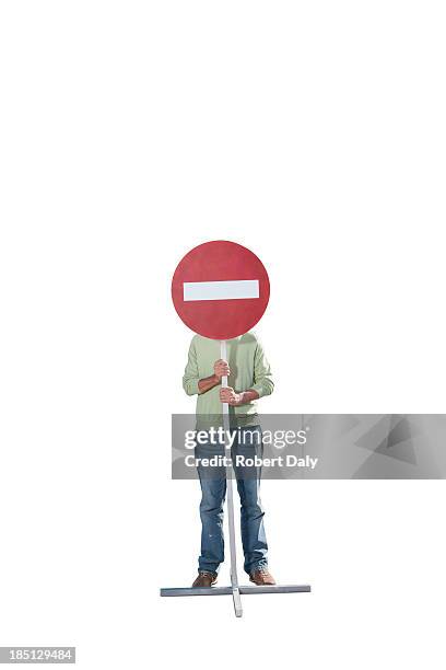 a man holding a sign  - señal de calle sin salida fotografías e imágenes de stock