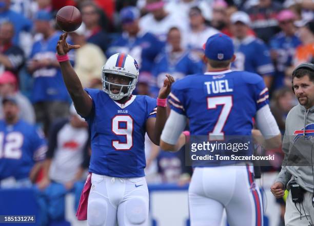 Thad Lewis of the Buffalo Bills warms up with Jeff Tuel during NFL game action against the Cincinnati Bengals at Ralph Wilson Stadium on October 13,...