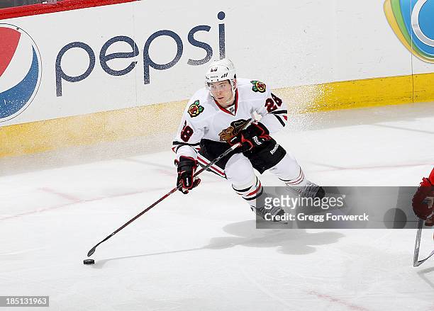 Ben Smith of the Chicago Blackhawks controls te puck on the ice during their NHL game against the Carolina Hurricanes at PNC Arena on October 15,...