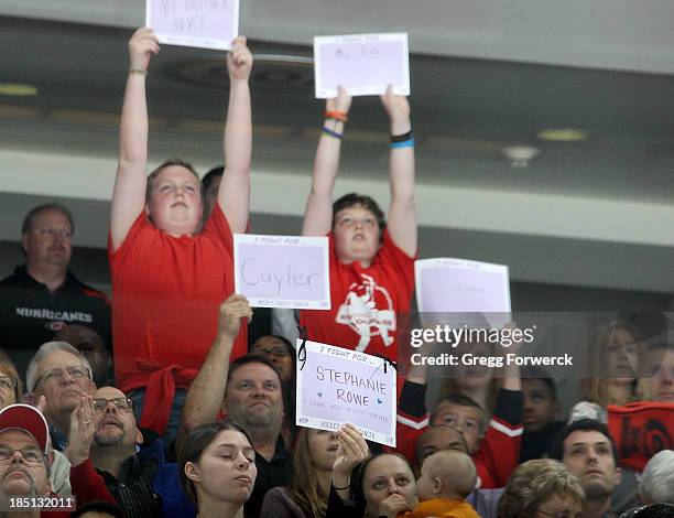 Fans participate in the Hockey Fights Cancer initiative during an NHL game between the Carolina Hurricanes and the Chicago Blackhawks at PNC Arena on...