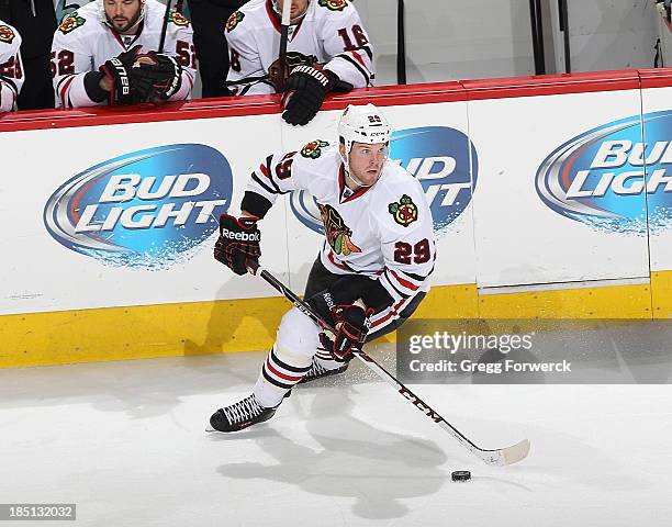 Bryan Bickell of the Chicago Blackhawks controls the puck along the boards during their NHL game against the Carolina Hurricanes at PNC Arena on...