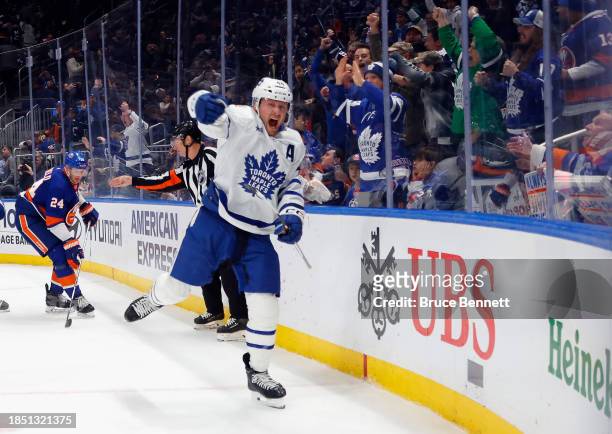 Morgan Rielly of the Toronto Maple Leafs scores at 19:53 of the third period against the New York Islanders at UBS Arena on December 11, 2023 in...