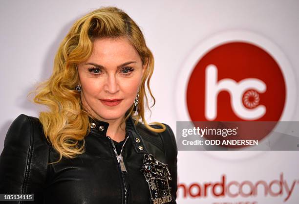 Pop star Madonna poses for photographers on the red carpet on the opening event of the Fitness Center "Hard Candy" on October 17, 2013 in Berlin. AFP...