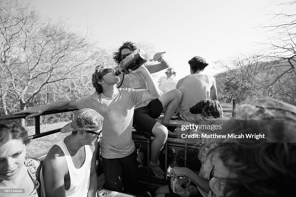 Friends take an open local truck taxi to an event