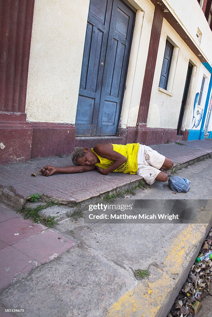 A local man lies passed out on a sidewalk