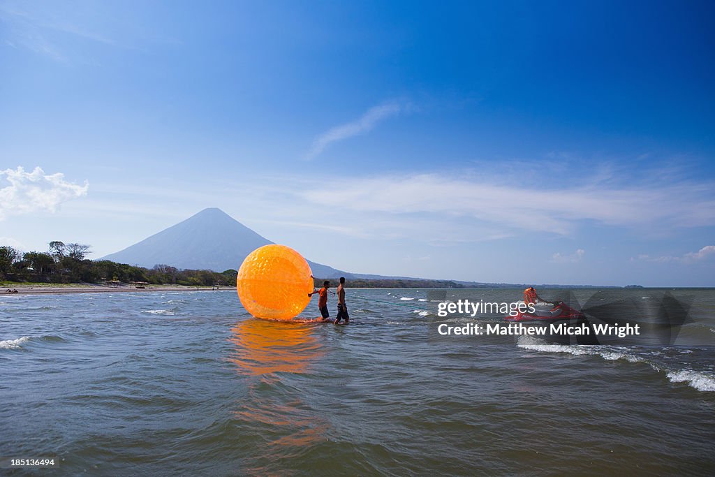 A person plays in a giant ball pulled by waterski