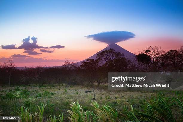 sunset falls behind the concepcion volcano - concepcion stock-fotos und bilder