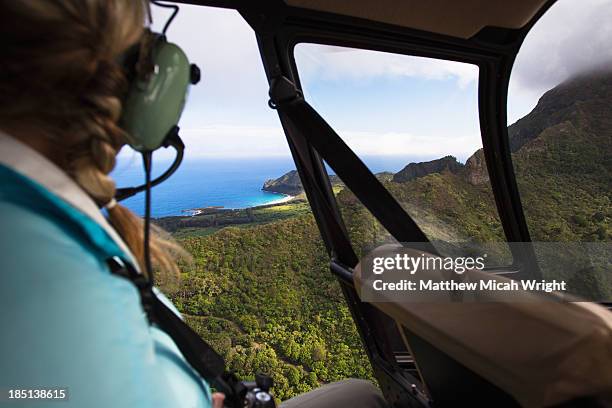 a woman enjoys views of kauai from a helicopter. - hawaii fun stock-fotos und bilder