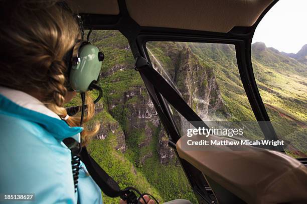 a woman enjoys views of kauai from a helicopter. - helicopter view stock pictures, royalty-free photos & images