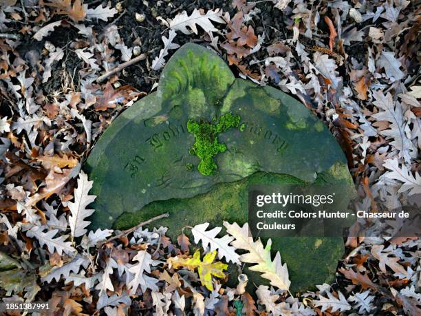 ancient funerary stele in patinated and damaged stone in the brompton cemetery of london, england, united kingdom - knightsbridge stock pictures, royalty-free photos & images