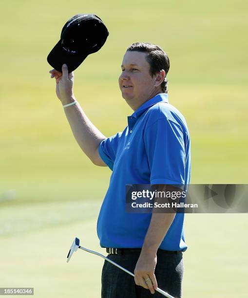 Henry waves to the gallery on the ninth green after finishing with an 11-under par 60 during the first round of the Shriners Hospitals for Children...