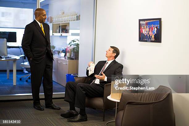 Head coach Lorenzo Romar of Washington speaks with head coach Ken Bone of Washington State during the PAC-12 Men's Basketball Media Day on October...