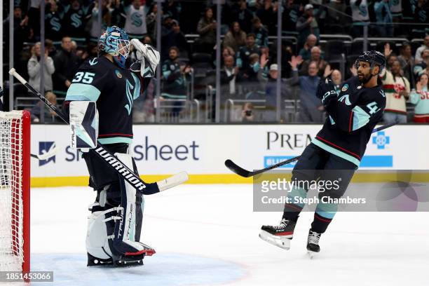 Joey Daccord of the Seattle Kraken celebrates his first NHL shutout with Pierre-Edouard Bellemare against Florida Panthers at Climate Pledge Arena on...