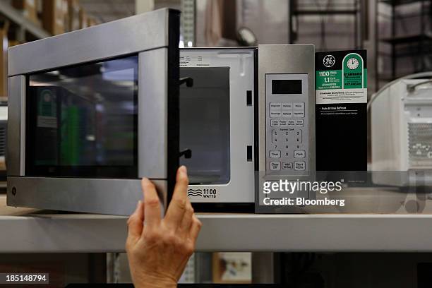 Customer views a General Electric Co. Microwave oven displayed for sale at a Lowe's Cos. Store in Torrance, California, U.S, on Thursday, Oct. 17,...