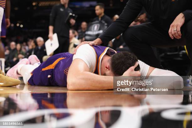 Jusuf Nurkic of the Phoenix Suns lays on the court after being fouled by Draymond Green of the Golden State Warriors during the second half of the...