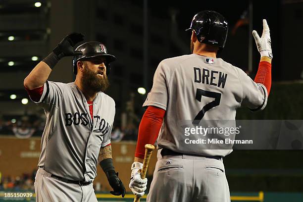 Mike Napoli celebrates his second inning solo homerun with Stephen Drew of the Boston Red Sox during Game Five of the American League Championship...