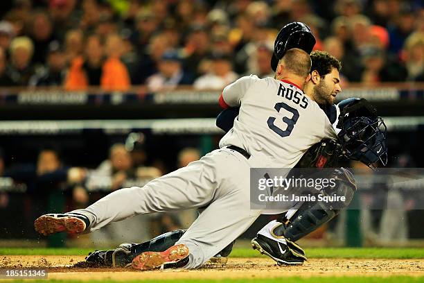 David Ross of the Boston Red Sox is out at home by Alex Avila of the Detroit Tigers in the second inning of Game Five of the American League...