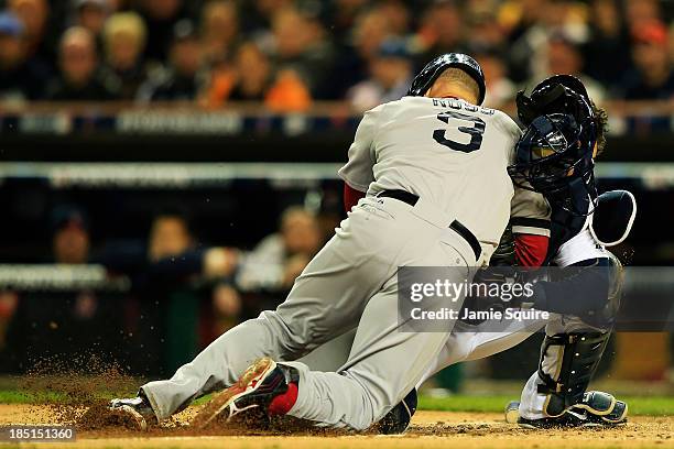 David Ross of the Boston Red Sox is out at home by Alex Avila of the Detroit Tigers in the second inning of Game Five of the American League...