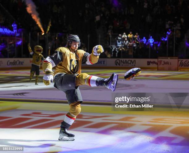 William Karlsson of the Vegas Golden Knights kicks a slot machine-themed pillow to fans after being named the second star of the game following the...