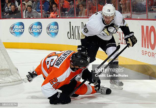 Joe Vitale of the Pittsburgh Penguins checks Erik Gustafsson of the Philadelphia Flyers to the ice behind the net on October 17, 2013 at the Wells...