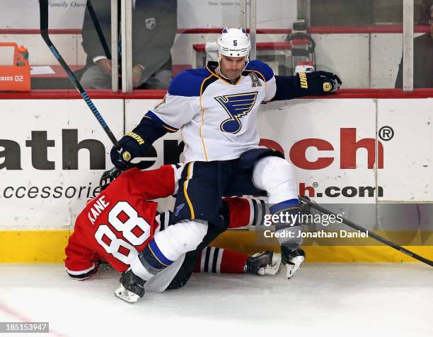 Patrick Kane of the Chicago Blackhawksis boarded by Barret Jackman of the St. Louis Blues at the United Center on October 17, 2013 in Chicago,...