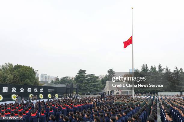 People attend the state memorial ceremony for China's National Memorial Day for Nanjing Massacre Victims at the Memorial Hall of the Victims of the...