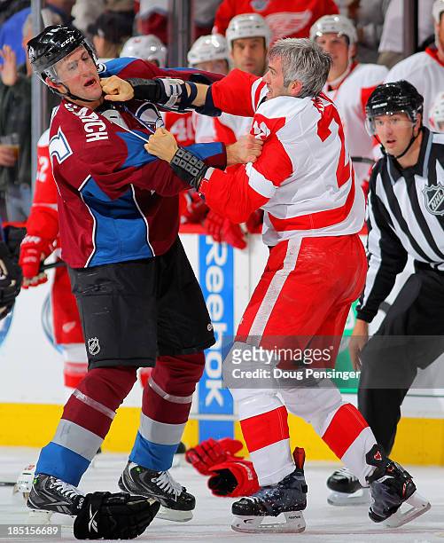 Cory Sarich of the Colorado Avalanche and Drew Miller of the Detroit Red Wings engage in a fight in the second period at Pepsi Center on October 17,...