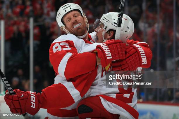 Johan Franzen of the Detroit Red Wings celebrates with Justin Abdelkader after Franzen scored the winning goal against the Colorado Avalanche in the...