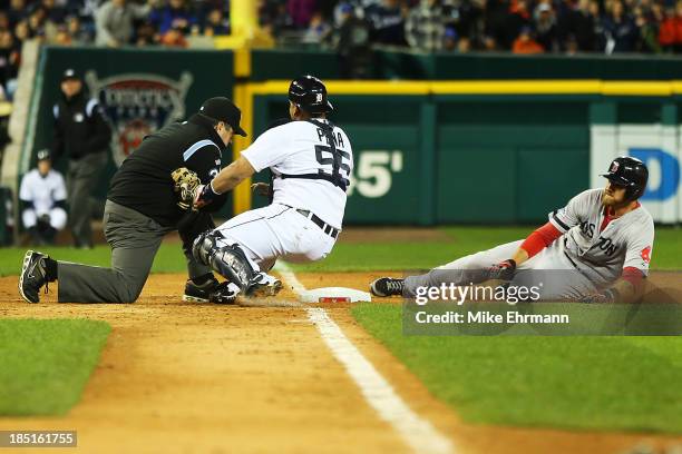 Will Middlebrooks of the Boston Red Sox slides into thid base safe against Brayan Pena of the Detroit Tigers in the ninth inning against the Detroit...