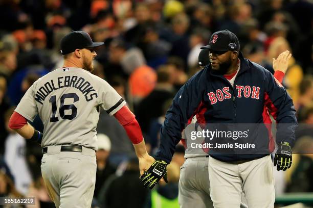 David Ortiz celebrates with Will Middlebrooks of the Boston Red Sox after they defeated the Detroit Tigers 4 to 3 in Game Five of the American League...