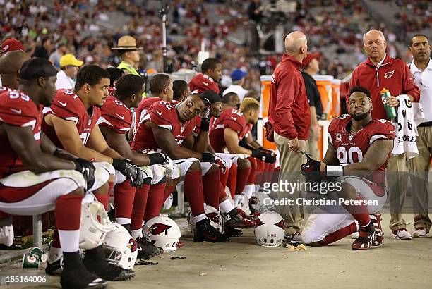 Inside linebacker Jasper Brinkley and defensive end Darnell Dockett of the Arizona Cardinals react on the bench with teamamtes during the final...