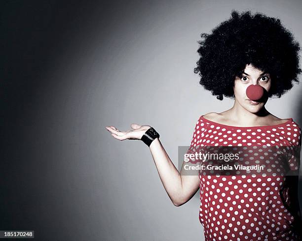 woman with red clown nose and red polka dot tshirt - clown nose stock pictures, royalty-free photos & images