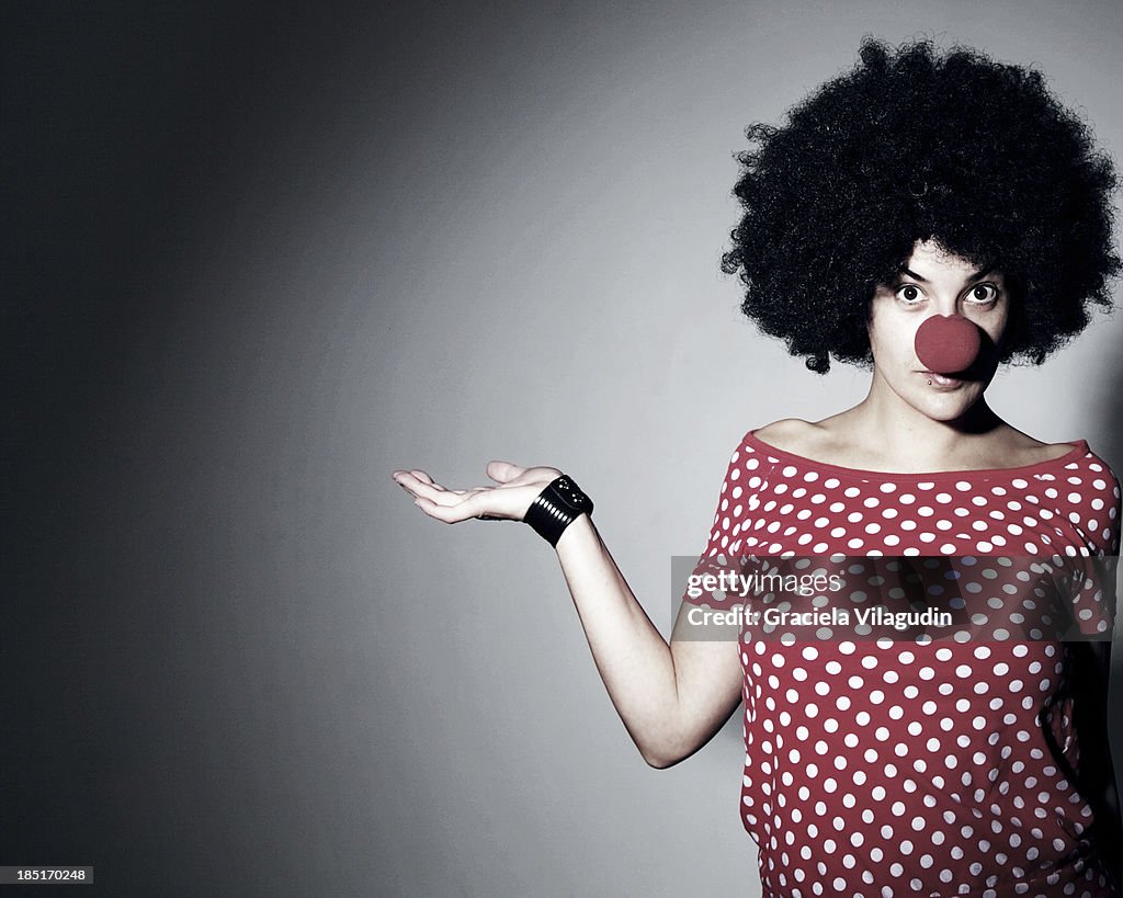 Woman with red clown nose and red polka dot tshirt
