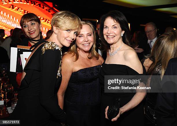 Actress Charlize Theron, wearing Alexander McQueen Resort 2014 dress, Gerda Jacoba Aletta Maritz, and former studio executive Sherry Lansing attend...