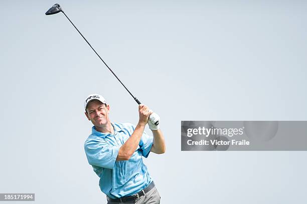 Simon Griffiths of England tees off on the 18th hole during day two of the Venetian Macau Open at Macau Golf and Country Club on October 18, 2013 in...