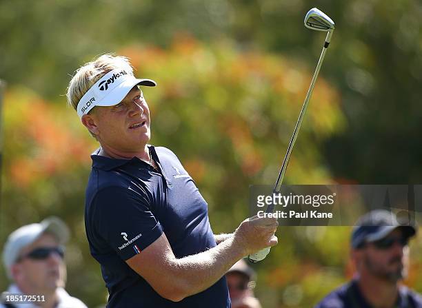 Peter Hedblom of Sweden watches his tee shot on the 13th hole during day two of the Perth International at Lake Karrinyup Country Club on October 18,...
